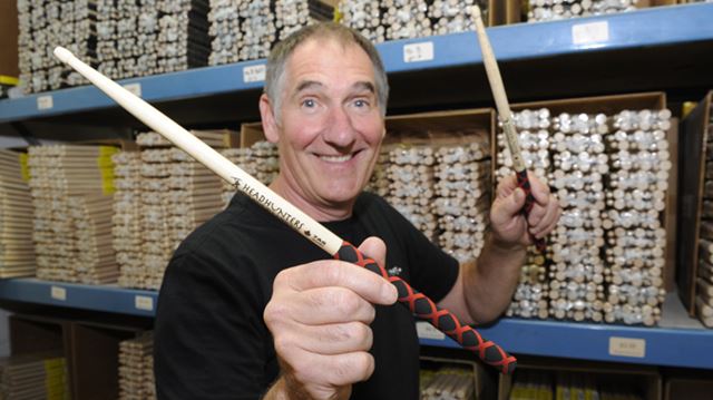 58916 BurlEdit Aug 25 2014 BURLINGTON - Dave Rundle of Headhunters drumsticks in front of racks of drumsticks inside his South Service Road shop. In photo Dave with a set of his new extreme rubber grip sticks. Graham Paine/ METROLAND MEDIA GROUP
